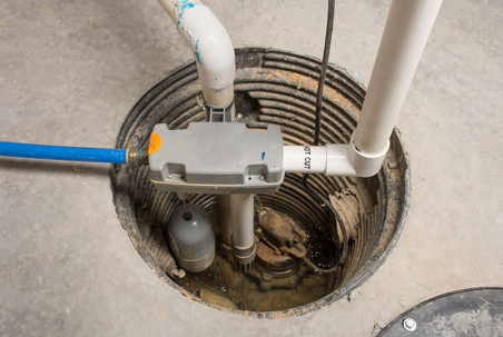 A sump pump sits in its pit